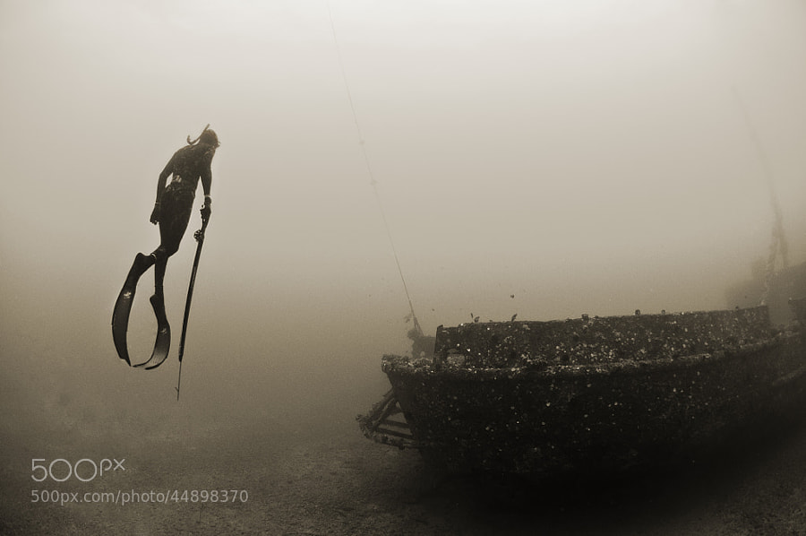 Photograph Free diver acsends from wreck by Kevin Boutwell on 500px