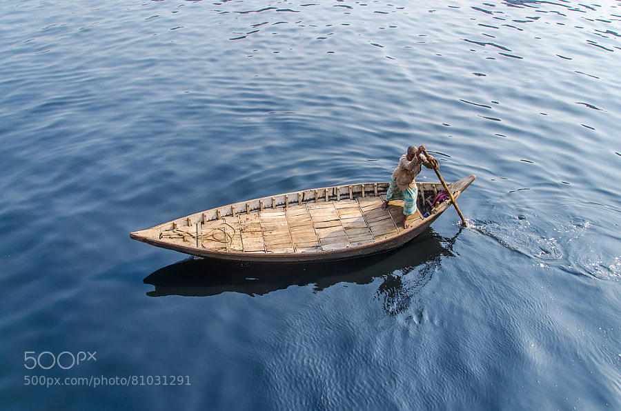 Photograph Man rowing a boat by Arju Rahman on 500px