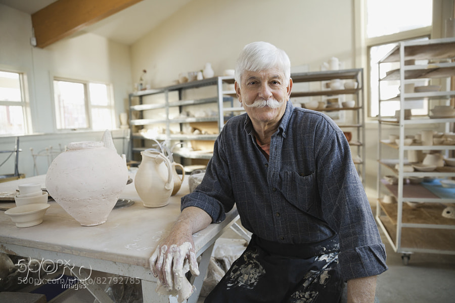 Photograph Portrait of man at pottery studio by Hero Images  on 500px