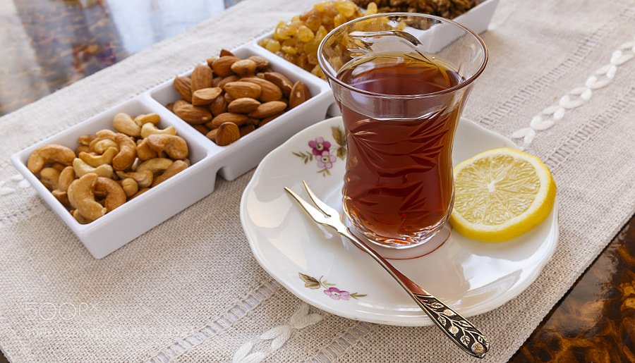 Photograph Azerbaijani tea with lemon and set nuts and sweets by Alexander Melnikov on 500px